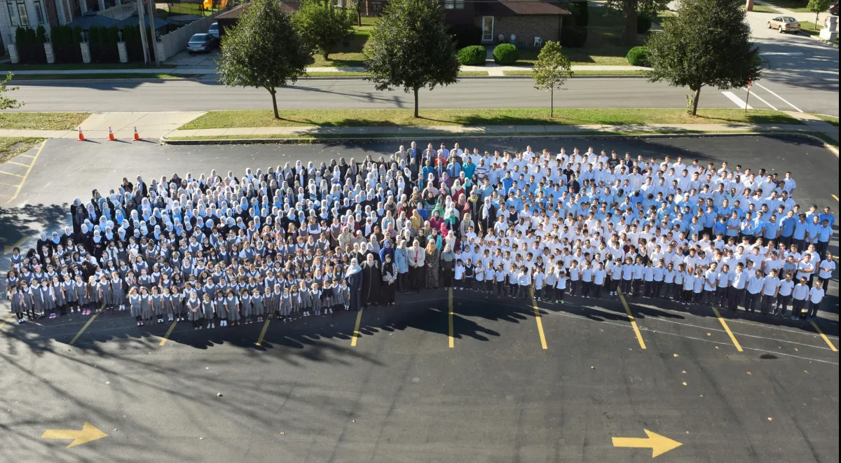 An aerial view of the whole Universal School community gathered in the parking lot
