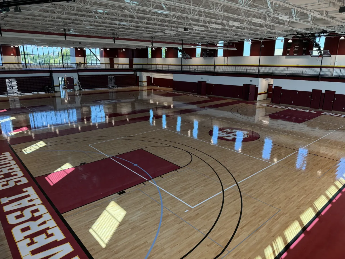 The Universal School gym with the school crest at center court