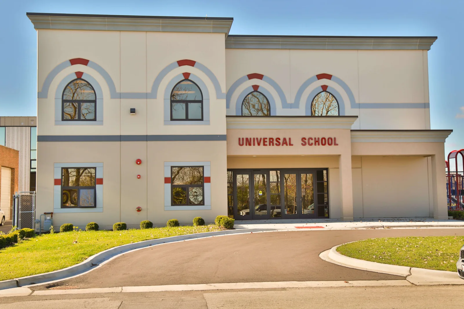 The front of the Universal School building on a clear day